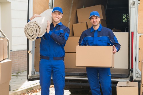 Removal team loading furniture into a van during a house move