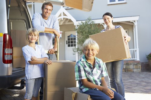 Moving team transporting bulky furniture through a London property