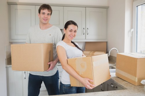 Professional movers handling boxes during same day removals